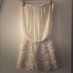 Windsor romper w/scalloped lace bottom.